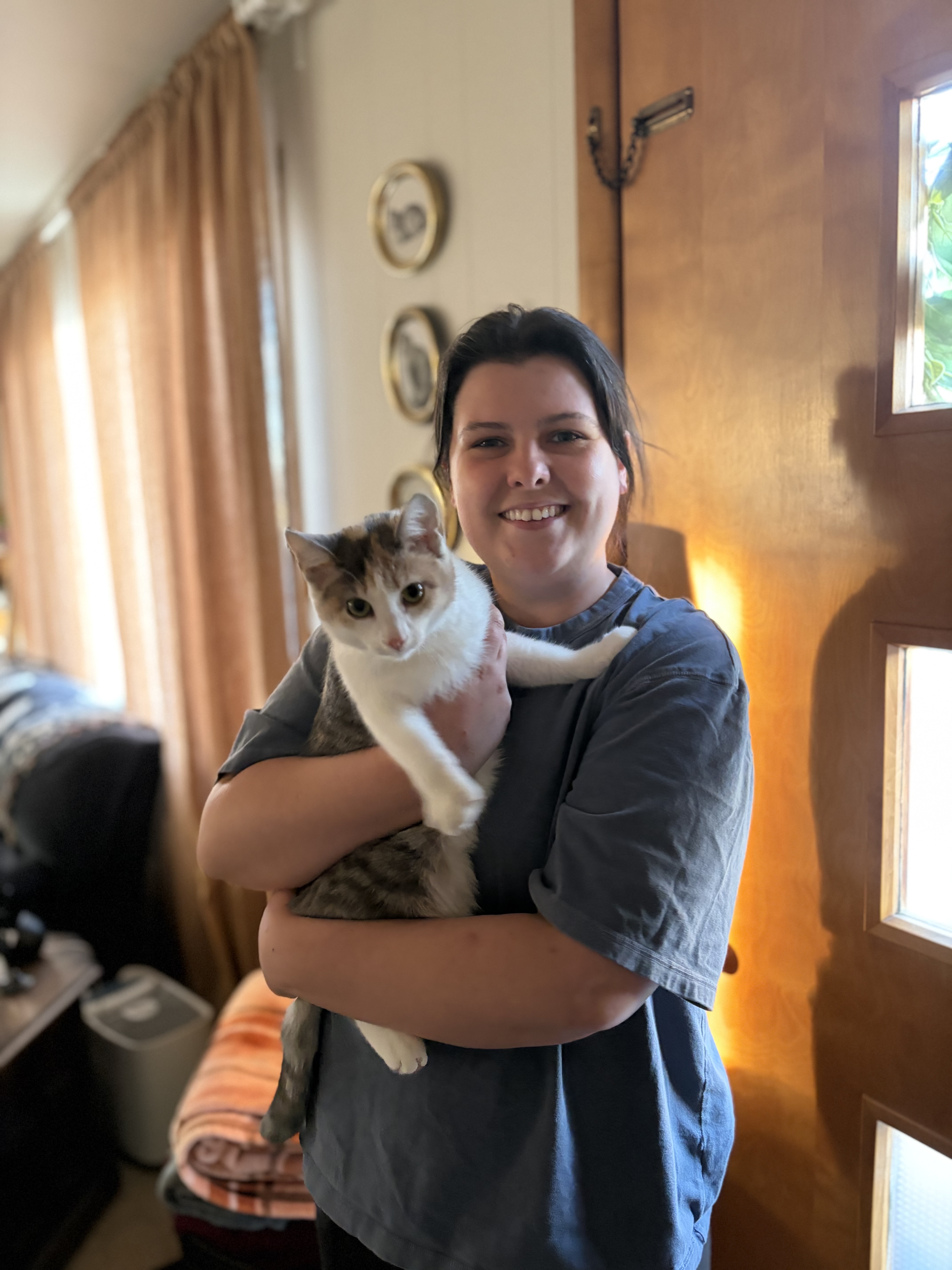 Picture of Jen holding her calico kitten, Juniper